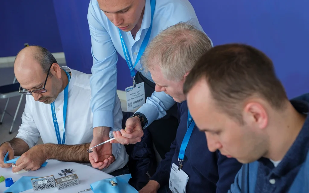 Speaker, John McQueen, instructs some delegates at a hands-on workshop.